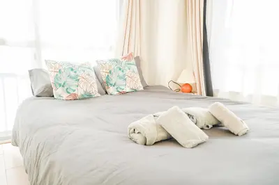 a bed with pillows and towels on it at 403Room 1 Stop from Ikebukuro Entire 35m on 4st Floor 2 Bedrooms for up to 6 Guests 3Minute Walk to Don Quijote in Tokyo