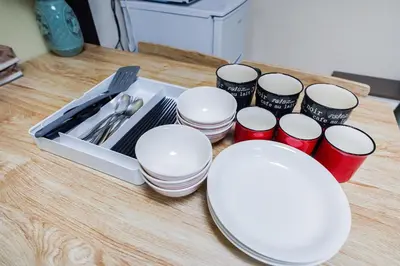 a group of white plates and cups on a table at 403Room 1 Stop from Ikebukuro Entire 35m on 4st Floor 2 Bedrooms for up to 6 Guests 3Minute Walk to Don Quijote in Tokyo