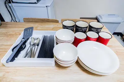 a tray of white plates and utensils on a table at 403Room 1 Stop from Ikebukuro Entire 35m on 4st Floor 2 Bedrooms for up to 6 Guests 3Minute Walk to Don Quijote in Tokyo