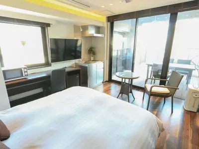 a bedroom with a bed and a desk and a table at HOTEL LiVEMAX Higashi Ginza in Tokyo