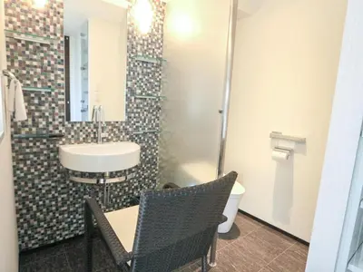 a bathroom with a sink and a toilet at HOTEL LiVEMAX Higashi Ginza in Tokyo