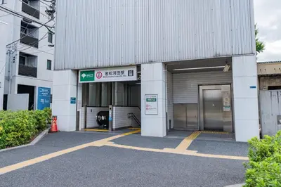 a large white building with a parking garage at unito residence SHINJUKU Wakamatsu in Tokyo