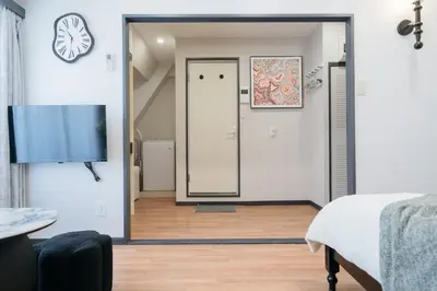 a bedroom with a door and a tv in a room at \u6771\u65b0\u5bbf-Shinjuku Area-Max3P-Vintage Style-St 3mins in Tokyo