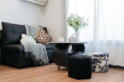 a living room with a black couch and a table at \u6771\u65b0\u5bbf-Shinjuku Area-Max3P-Vintage Style-St 3mins in Tokyo