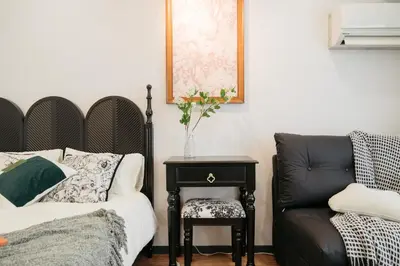 a bedroom with a bed and a chair and a table at \u6771\u65b0\u5bbf-Shinjuku Area-Max3P-Vintage Style-St 3mins in Tokyo