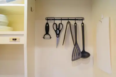 a rack of kitchen utensils hanging on a wall at \u6771\u65b0\u5bbf-Shinjuku Area-Max3P-Vintage Style-St 3mins in Tokyo
