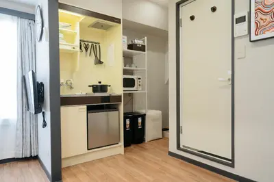 a small kitchen with a sink and a microwave at \u6771\u65b0\u5bbf-Shinjuku Area-Max3P-Vintage Style-St 3mins in Tokyo