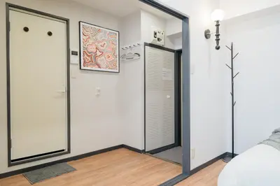 a bedroom with white walls and a closet with a mirror at \u6771\u65b0\u5bbf-Shinjuku Area-Max3P-Vintage Style-St 3mins in Tokyo
