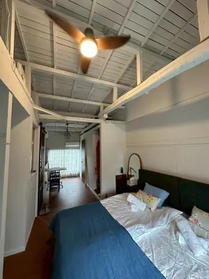 a bedroom with a blue bed with a ceiling fan at Runbull House in Tokyo