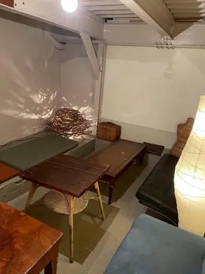 a room with tables and chairs in a room at Runbull House in Tokyo