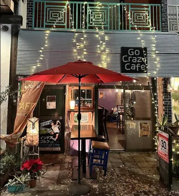 a red umbrella sitting in front of a cafe at Runbull House in Tokyo