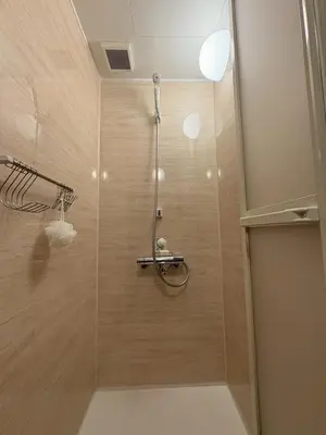 a shower with a glass door in a bathroom at Runbull House in Tokyo