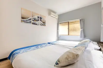 a bedroom with two beds and a window at Nnb\u938c\u50094\u4e01\u76ee in Tokyo