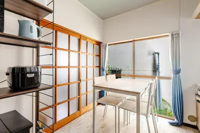 a kitchen with a table and chairs in a room at Nnb\u938c\u50094\u4e01\u76ee in Tokyo
