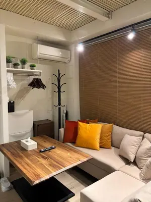 a living room with a couch and a wooden table at Tkm\u767d\u91d15\u4e01\u76ee in Tokyo