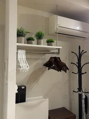 a kitchen with white shelves with plants on them at Tkm\u767d\u91d15\u4e01\u76ee in Tokyo