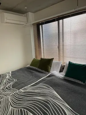 a bedroom with a large bed with a large window at Tkm\u767d\u91d15\u4e01\u76ee in Tokyo