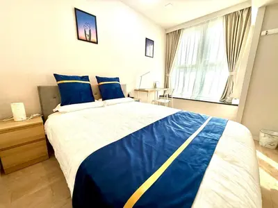 a bedroom with a large bed with blue and white sheets at SELENTE-S3 - Tokyo Tower 2BR - Central Tokyo in Tokyo