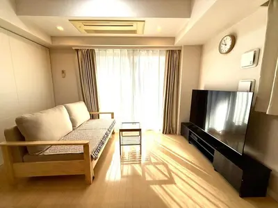 a living room with a couch and a flat screen tv at SELENTE-S3 - Tokyo Tower 2BR - Central Tokyo in Tokyo