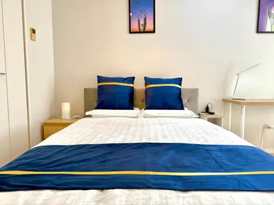 a bed with blue and yellow pillows in a room at SELENTE-S3 - Tokyo Tower 2BR - Central Tokyo in Tokyo
