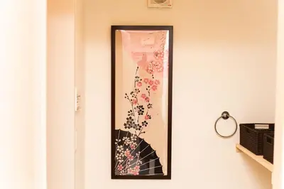 a picture of an umbrella on a wall at Imb\u753a\u5c4b4\u4e01\u76ee302 in Tokyo
