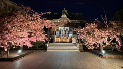 a building with pink flowering trees in front of it at SAKURA HOUSE 206, Sakura Shinmachi St 2 min walk, Shibuya 10 min, Free WiFi in Tokyo