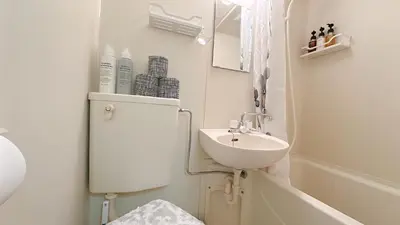 a white bathroom with a sink and a bath tub at SAKURA HOUSE 206, Sakura Shinmachi St 2 min walk, Shibuya 10 min, Free WiFi in Tokyo