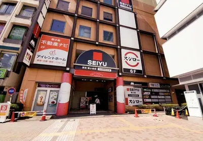 a building with signs on the front of it at Kaga house1 in Tokyo