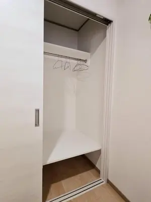 a walk in closet with white walls and a mirror at Kaga house1 in Tokyo
