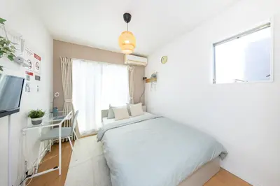 a small bedroom with a bed and a window at The House IKEBUKURO 301 in Tokyo