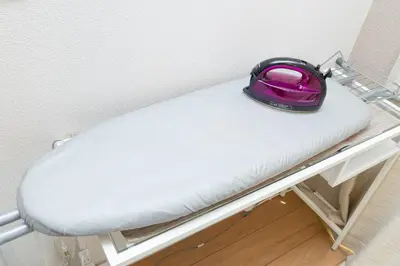 a pink bag sitting on top of a bed at The House IKEBUKURO 301 in Tokyo