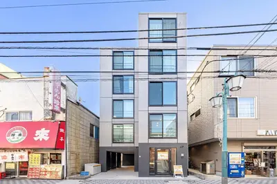 a building on a city street with buildings at Casa-T\u4e94\u53cd\u91ce in Tokyo