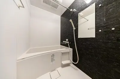 a white bathroom with a shower and a black wall at Casa-T\u4e94\u53cd\u91ce in Tokyo