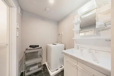 a white bathroom with a sink and a toilet at Casa-T\u4e94\u53cd\u91ce in Tokyo