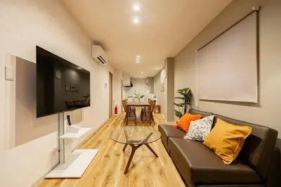 a living room with a couch and a table at Lino Stay Kasai 'elua in Tokyo