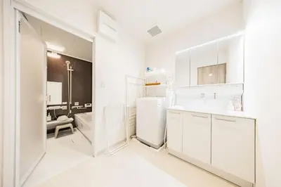 a white kitchen with a sink and a refrigerator at Lino Stay Kasai 'elua in Tokyo