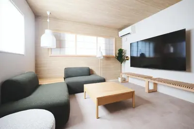 a living room with two chairs and a tv at Ebisu4HOTEL in Tokyo