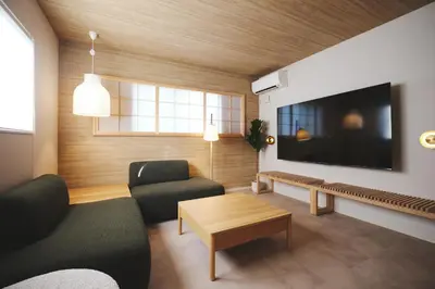 a living room with a couch and a tv at Ebisu4HOTEL in Tokyo
