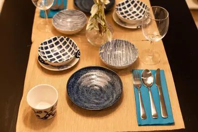 a table with blue and white plates and wine glasses at Imb\u753a\u5c4b4\u4e01\u76ee201 in Tokyo