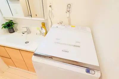 a white refrigerator in a kitchen with a sink at Higashijūjō, Kita City house KI0321 in Tokyo