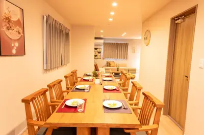 a dining room with a long wooden table and chairs at HOTEL Grand Star TATEISHI SEVEN in Tokyo