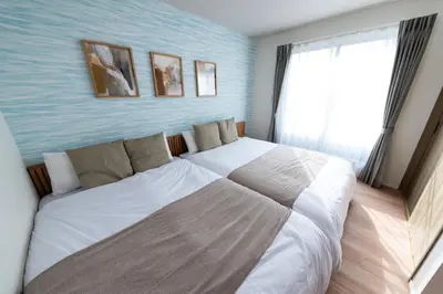 a bedroom with a large white bed and a window at HOTEL Grand Star TATEISHI SEVEN in Tokyo