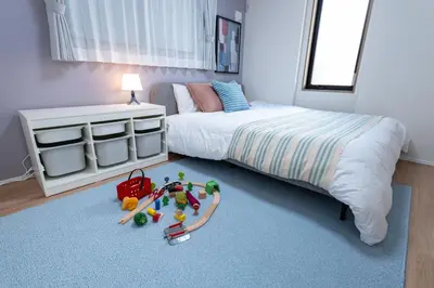 a bedroom with a bed and toys on the floor at HOTEL Grand Star TATEISHI SEVEN in Tokyo