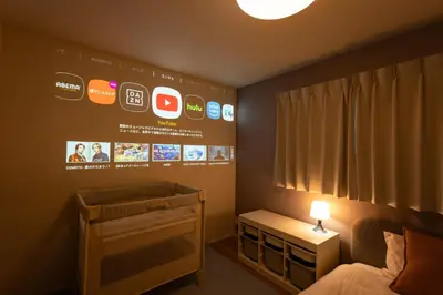 a bedroom with a crib and a sign on the wall at HOTEL Grand Star TATEISHI SEVEN in Tokyo