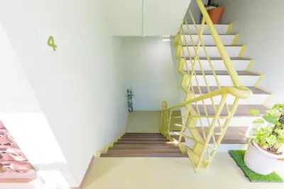 a spiral staircase in a room with potted plants at HANEZORA HOTEL itabashi 3F4F in Tokyo