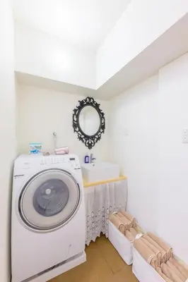 a laundry room with a washing machine and a sink at HANEZORA HOTEL itabashi 3F4F in Tokyo