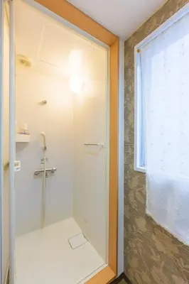a shower with a glass door in a bathroom at HANEZORA HOTEL itabashi 3F4F in Tokyo