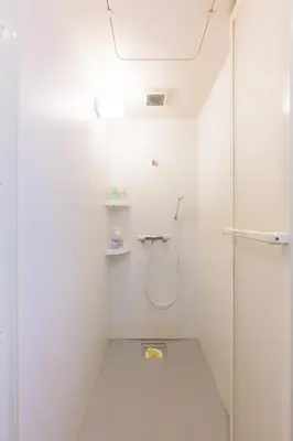 a white bathroom with a shower and a glass door at HANEZORA HOTEL itabashi 3F4F in Tokyo