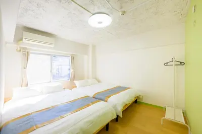 a large bed in a room with a window at HANEZORA HOTEL itabashi 3F4F in Tokyo
