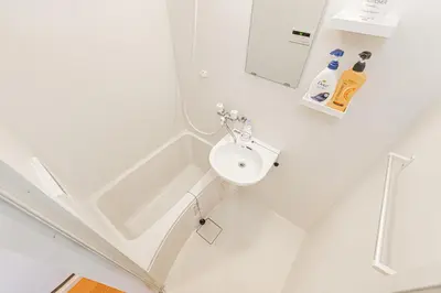 a bathroom with a sink and a shower at 67 Apartment Hotel Asakusa in Tokyo